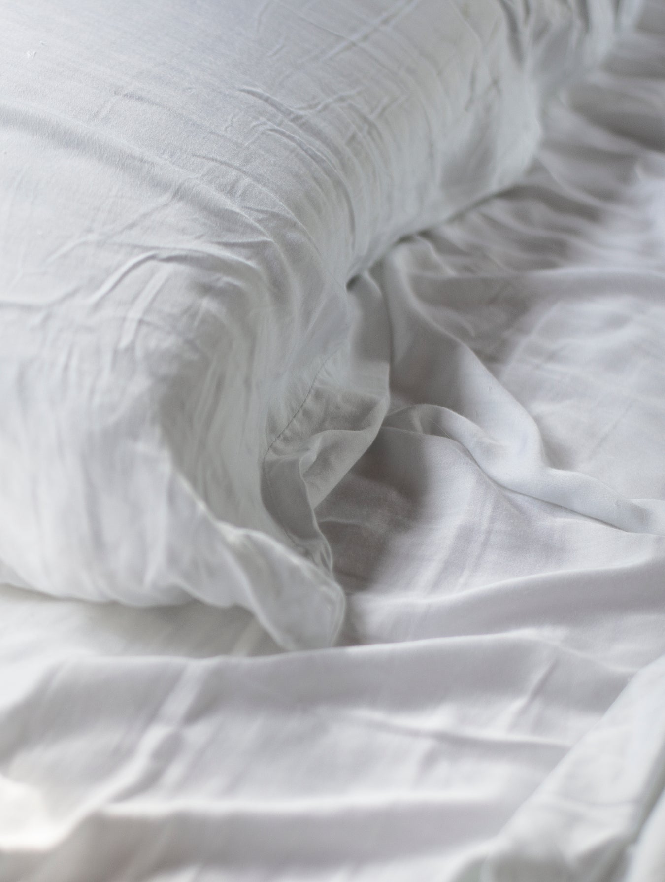 Image of white color bed sheet and pillowcase